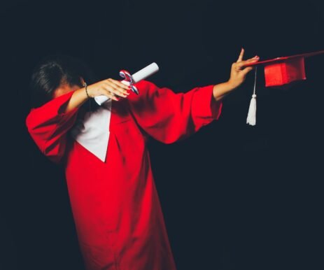 person wearing red graduation dress